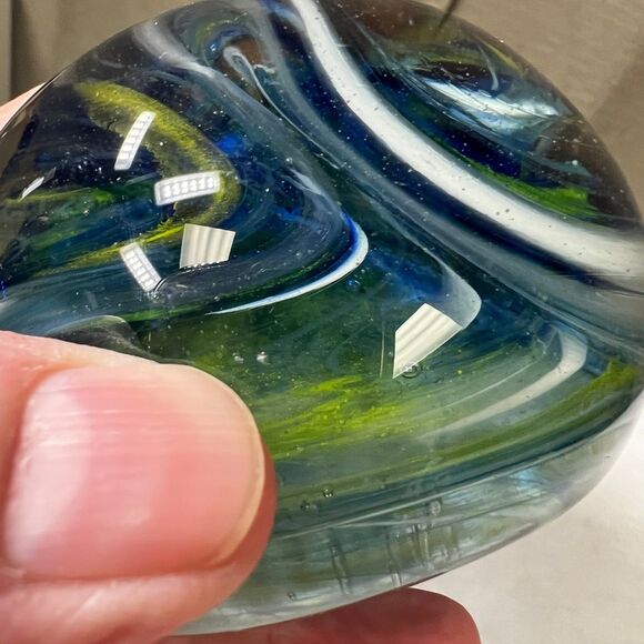 Clear glass round paperweight with blue and green swirls - Picture 7 of 7
